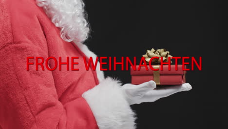 Frohe-weihnachten-text-in-red-over-father-christmas-holding-gift-on-black-background