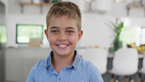 Portrait-of-happy-caucasian-boy-looking-at-camera-and-smiling,-slow-motion