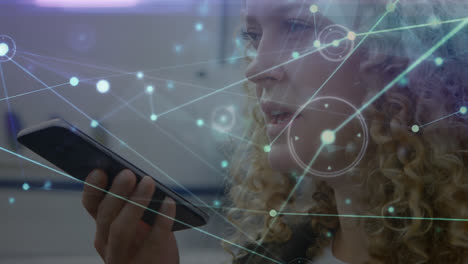 Animation-of-connected-dots-over-caucasian-woman-talking-on-speaker-over-cellphone-at-airport