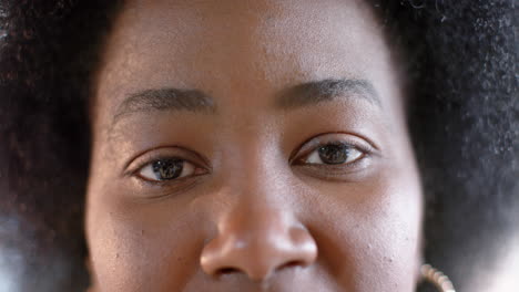 Portrait-of-eyes-of-african-american-casual-businesswoman-with-afro-in-office,-slow-motion