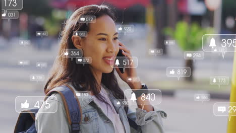 Animación-Del-Procesamiento-De-Datos-De-Redes-Sociales-Sobre-Una-Mujer-Asiática-Que-Usa-Un-Teléfono-Inteligente-En-La-Ciudad