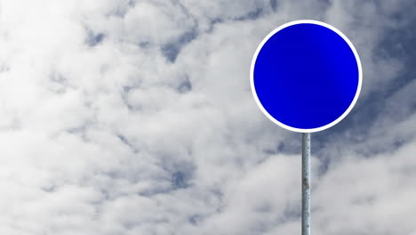 Animation-of-round-signboard-with-copy-space-against-clouds-in-the-blue-sky