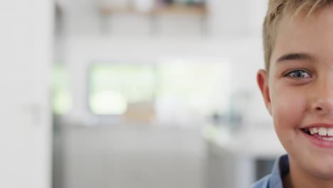 Portrait-of-happy-caucasian-boy-looking-at-camera-and-smiling,-copy-space,-slow-motion