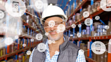 Animation-of-network-of-connections-with-icons-over-caucasian-male-worker-working-in-warehouse