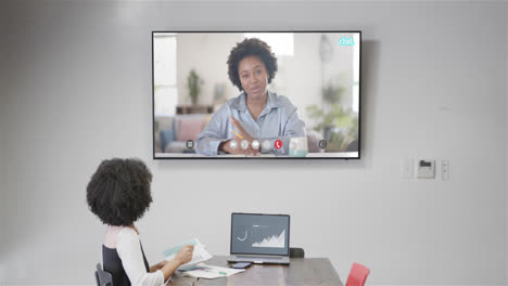 African-american-businesswoman-on-video-call-with-african-american-female-colleague-on-screen