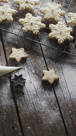 Vertical-video-of-star-christmas-cookies-with-sugar-and-copy-space-on-wooden-background