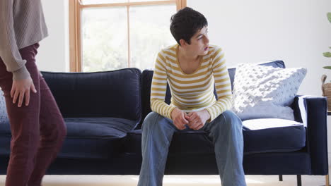 Happy-caucasian-lesbian-couple-sitting-on-sofa,-embracing-and-supporting-each-other-in-sunny-house