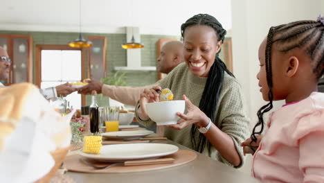 African-american-parents,-children-and-grandparents-celebrating-at-thanksgiving-dinner,-slow-motion