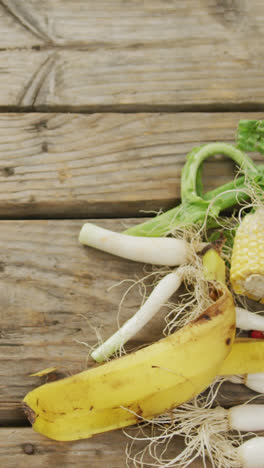 Video-of-white-compost-bin-with-organic-waste-and-copy-space-on-grey-wooden-background