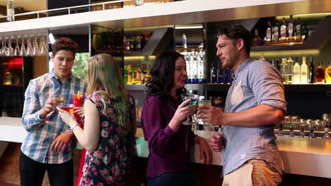 Attractive-friends-talking-and-drinking-at-the-bar