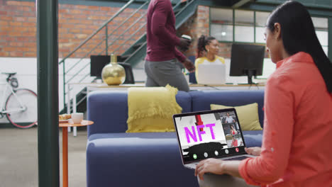 Biracial-businesswoman-using-laptop-for-video-call-with-diverse-business-colleagues