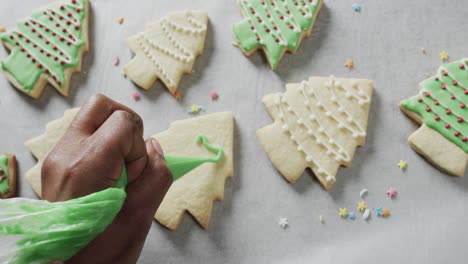 Video-of-christma-cookies-being-decorated-with-green-sugar-icing-with-copy-space-on-white-background