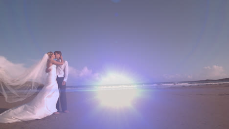 Animation-of-light-moving-over-happy-caucasian-newly-married-couple-on-beach