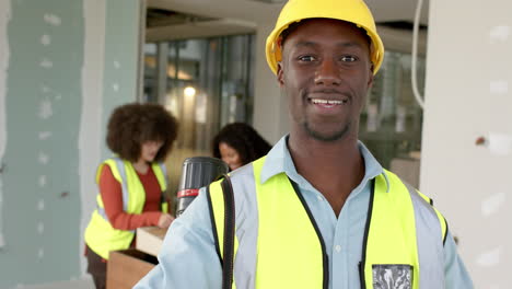 Casual-african-american-male-architect-looking-at-plans-in-office,-slow-motion,-copy-space