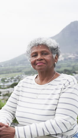 Vertical-video-of-portrait-of-smiling-senior-african-american-woman,-copy-space,-slow-motion