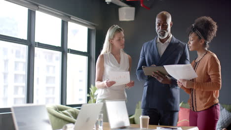 Diverse-business-people-discussing-in-office-with-copy-space