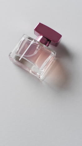 Vertical-video-of-perfume-bottle-and-copy-space-on-white-background