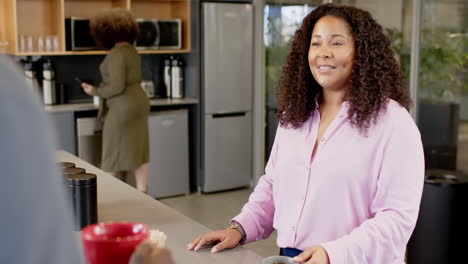 Smiling-casual-biracial-businesswoman-in-office,-slow-motion-with-copy-space