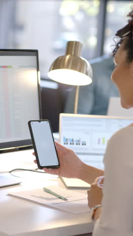 Vertical-video-of-caucasian-businesswoman-using-smartphone-with-copy-space,-slow-motion