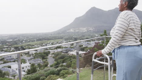 Senior-african-american-woman-with-walking-frame-on-balcony,-copy-space,-slow-motion