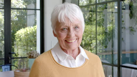 Portrait-of-happy-senior-caucasian-woman-smiling-at-home,-slow-motion