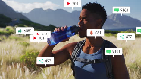 Animation-of-notification-bars-over-biracial-man-drinking-water-against-mountain-and-cloudy-sky