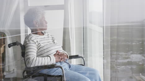 Senior-african-american-woman-in-wheelchair-by-window,-copy-space,-slow-motion