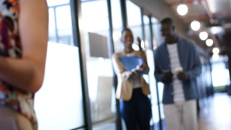 African-american-businessman-discussing-with-female-colleague-in-office,-slow-motion,-copy-space