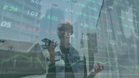 Animation-of-multicolored-trading-board-over-smiling-biracial-woman-talking-on-speaker-of-cellphone