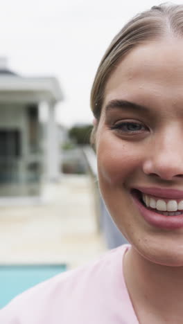 Vertical-video-of-smiling-caucasian-female-nurse,-slow-motion