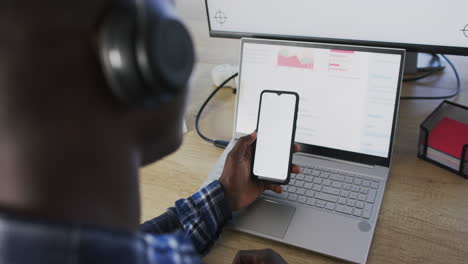 African-american-businessman-using-smartphone-with-blank-screen-in-office,-slow-motion,-copy-space