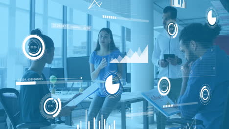 Animation-of-graphs,-loading-circles-and-bars-over-diverse-woman-explaining-reports-to-coworkers