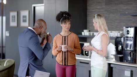 Diverse-business-people-discussing-on-a-coffee-break-in-office-with-copy-space