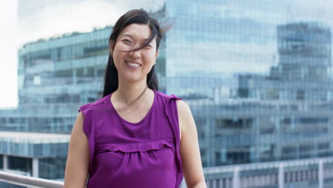 Portrait-of-smiling-asian-businesswoman-in-office,-slow-motion,-copy-space