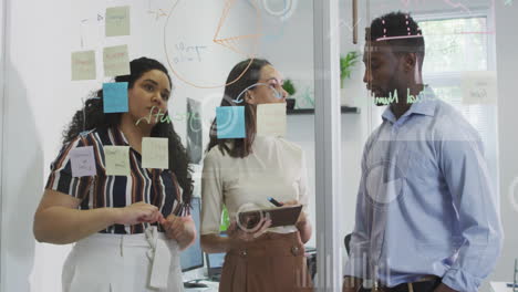 Animation-of-graphs-and-loading-circles-over-diverse-coworkers-discussing-strategy-in-office