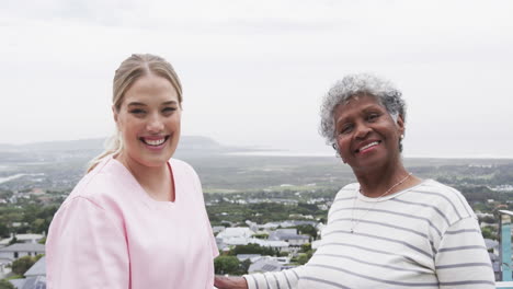 Smiling-caucasian-female-nurse-and-senior-african-american-woman,-copy-space,-slow-motion