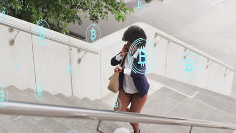 Animation-of-african-american-woman-talking-on-phone-and-looking-at-watch-while-walking-up-stairs