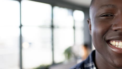 Portrait-of-smiling-african-american-businessman-in-office,-slow-motion,-copy-space