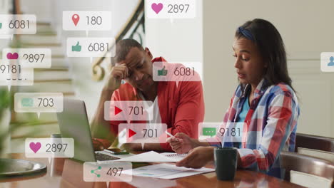 Animation-of-multiple-notification-bars-over-diverse-couple-calculating-expenses-at-home