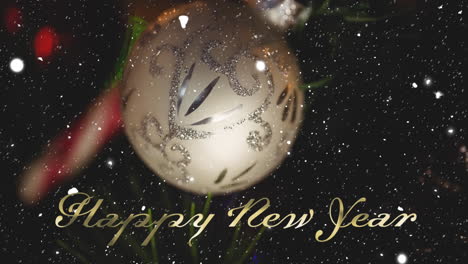Animation-of-happy-new-year-text-over-snow-falling-and-christmas-bauble-on-black-background