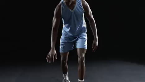 African-American-basketball-player-in-a-focused-pose-on-a-black-background