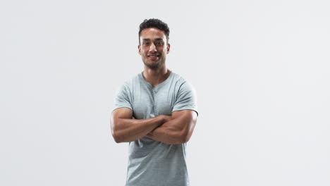 Confident-young-biracial-athlete-man-posing-in-a-studio-on-a-white-background