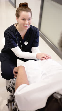 Vertical-video-of-senior-african-american-woman-and-female-doctor,-slow-motion,-copy-space