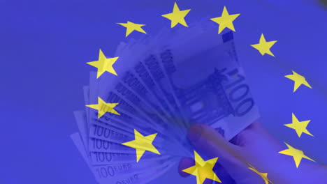 Animation-of-flag-of-european-union-over-euro-currency-bills