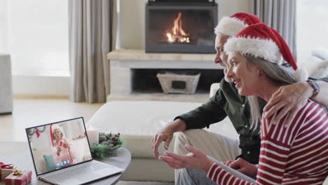 Happy-diverse-senior-couple-and-female-friend-having-christmas-laptop-video-call,-slow-motion