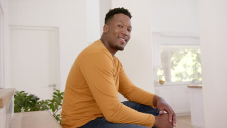 Portrait-of-happy-african-american-man-with-short-hair-at-home,-slow-motion