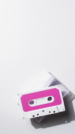 Vertical-video-of-retro-tape-with-pink-label-and-copy-space-on-white-background
