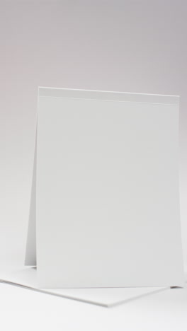 Vertical-video-of-book-with-white-blank-pages-and-copy-space-on-white-background