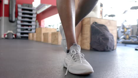 Close-up-of-a-person's-legs-walking-in-a-gym,-with-copy-space