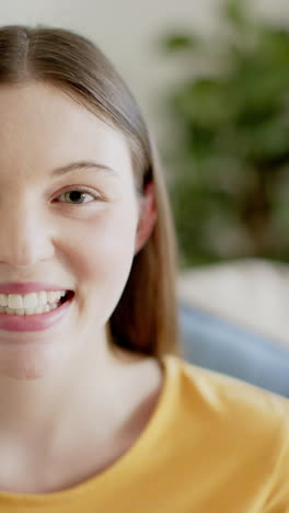 Vertical-video-of-portrait-of-happy-caucasian-woman-at-home,-in-slow-motion